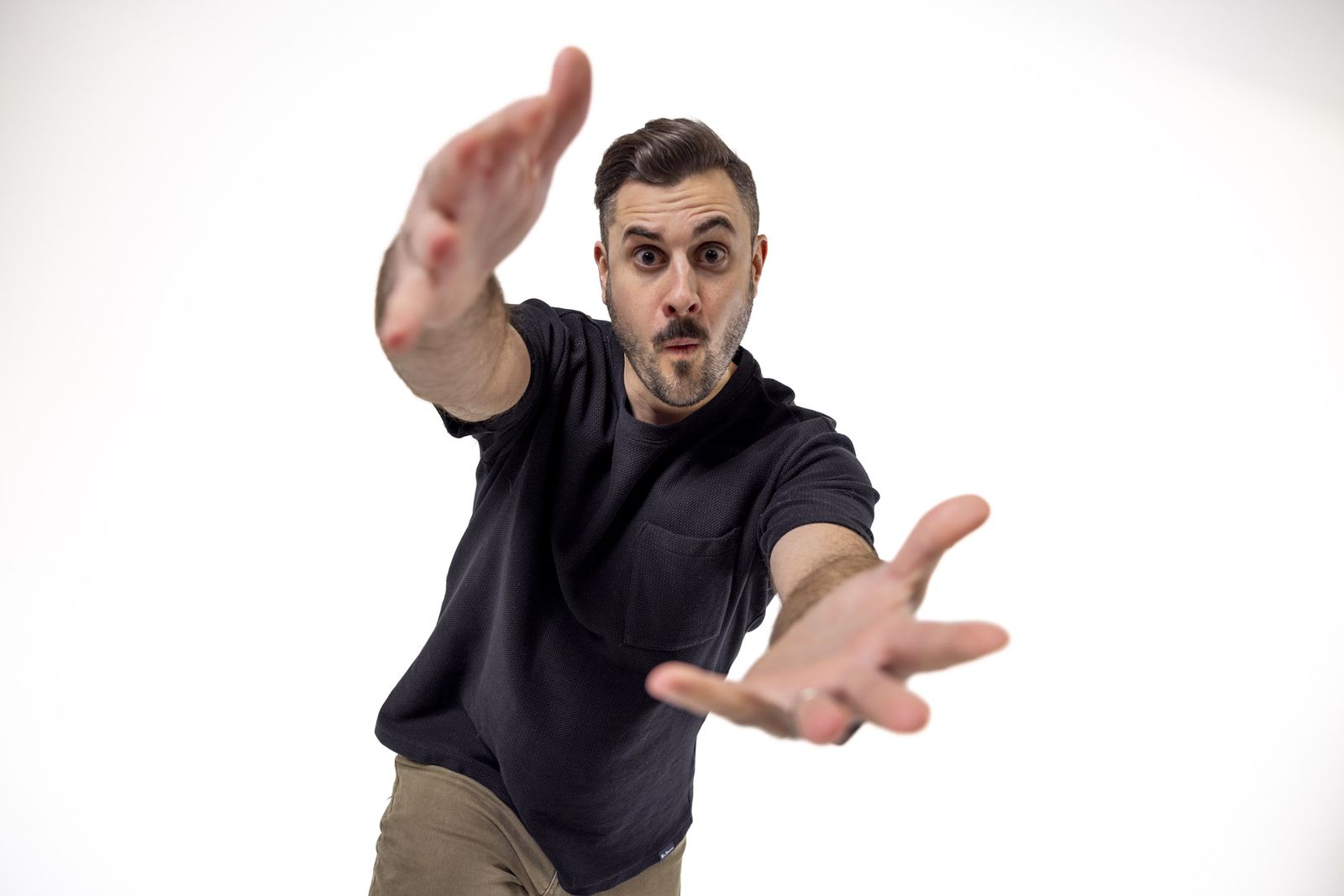 Taylor Blaylock reaching toward the camera with a surprised expression